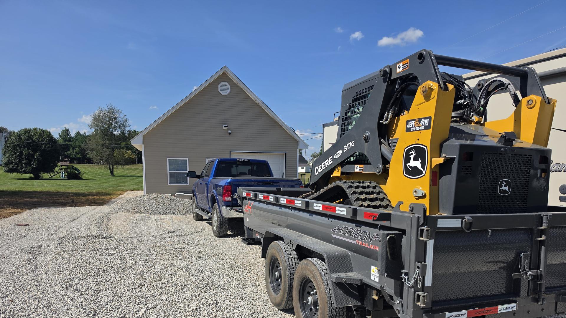 Jeff Dirt's compact track loader with the bucket down on a freshly built gravel pad at a building site near Rineyville, Kentucky.